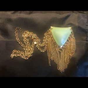 Vintage triangle shaped light green crystal like stone.